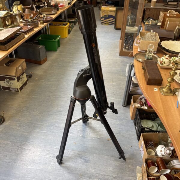 Celestron Nexstar 90GT telescope on tripod for astronomical viewing.