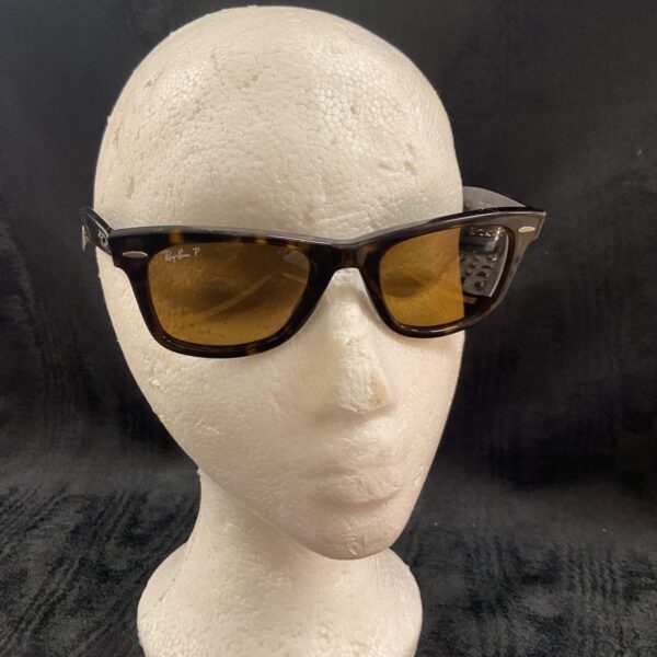 Front view of vintage Ray Ban Wayfarer sunglasses on a mannequin head.