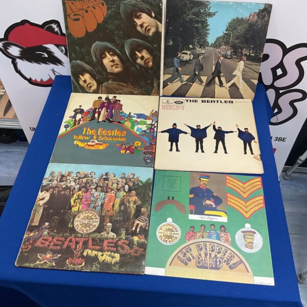 Front covers of a Beatles vinyl record collection.