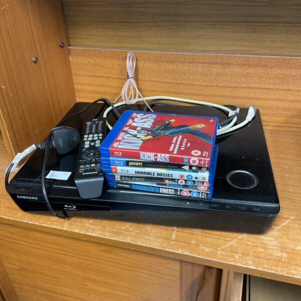 Samsung Blu-Ray player with remote and movie discs.
