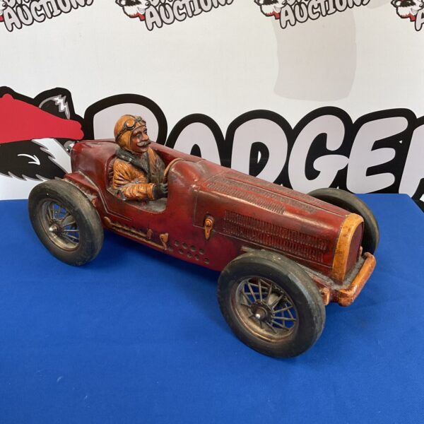 Red fibreglass classic race car model with driver figure.