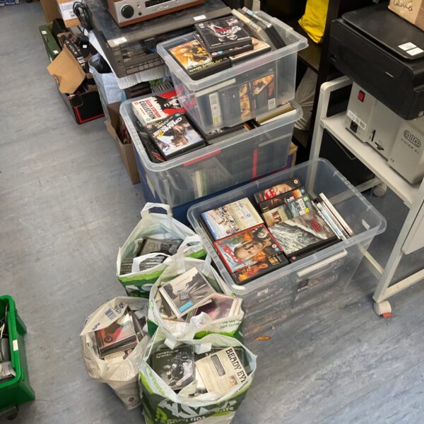 Large joblot of DVDs and CDs in plastic storage boxes.