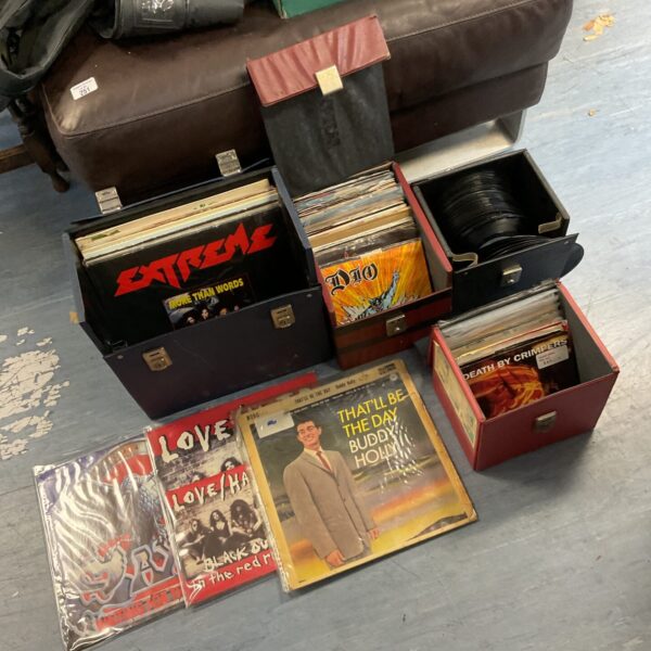 Vintage carrying case filled with a diverse vinyl record collection.