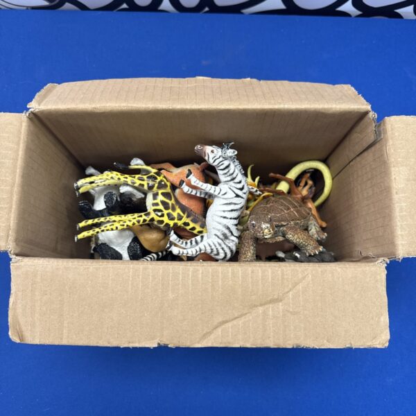 Plastic toy animal lot featuring giraffe, zebra, and turtle figures.