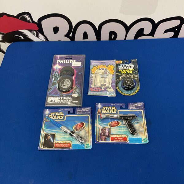 Star Wars memorabilia lot featuring Darth Vader earphones, yoyo, lightsaber and pistol.