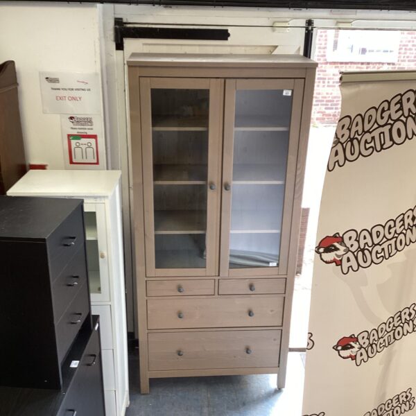 White Ikea Hemnes glass door cabinet with four drawers.