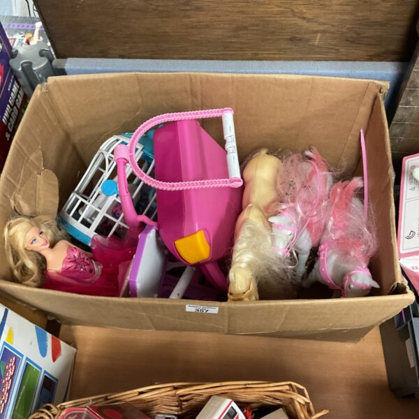 Vintage Barbie doll lot with horses and accessories for collectors.