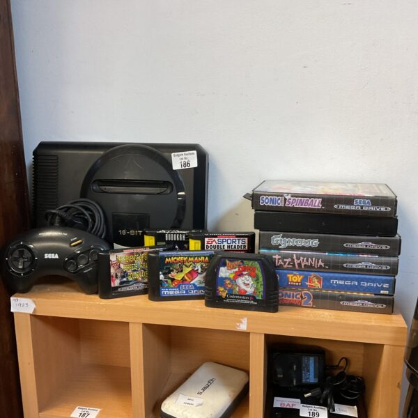 Sega Megadrive console with game cartridges for retro gaming.