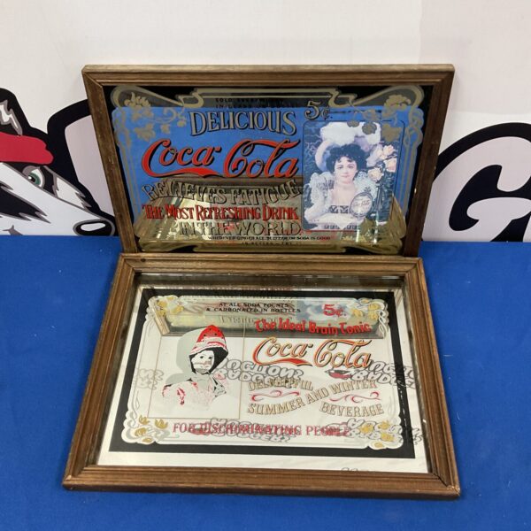 Vintage Coca Cola mirror with classic advertising design.