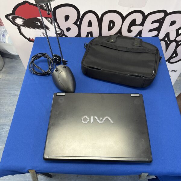 Retro Sony Vaio laptop with desk lamp and satchel.