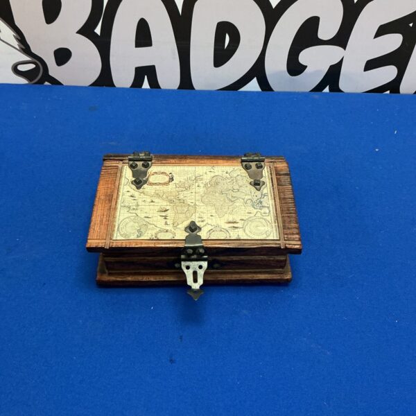 Front view of vintage wooden world map money box.