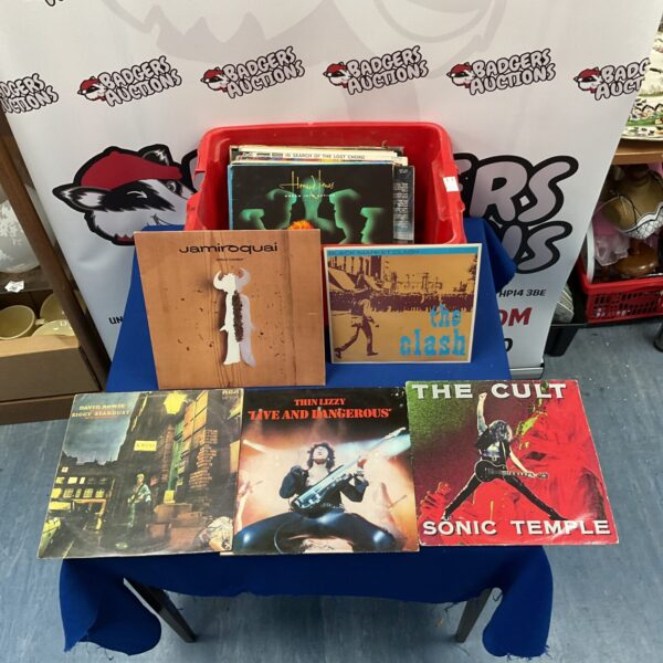 Lot of vinyl records including David Bowie, Jamiroquai, and The Clash.