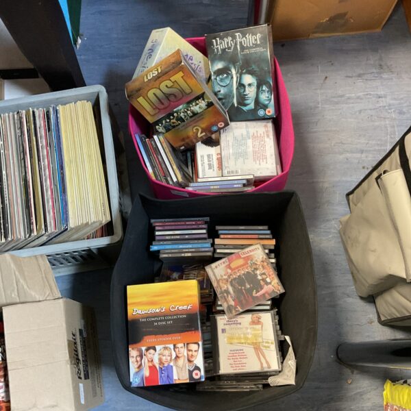Mixed lot of boxed CDs and DVDs including Harry Potter and Lost.