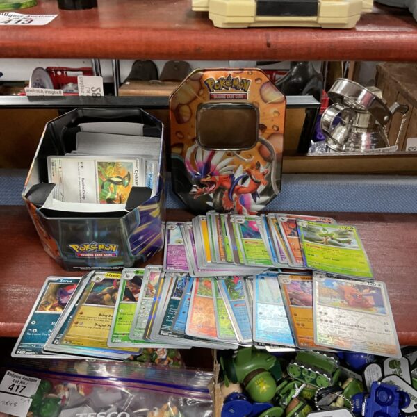Colourful Pokémon card tin with holographic trading cards inside.