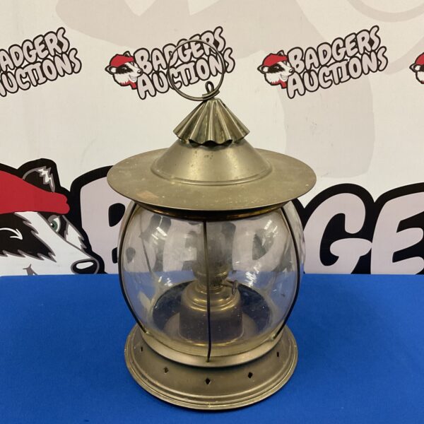 Vintage brass storm lantern with clear glass globe.