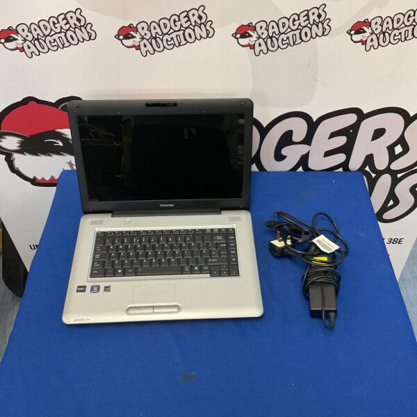Toshiba Satellite Pro L450D laptop with charger, vintage portable computer.