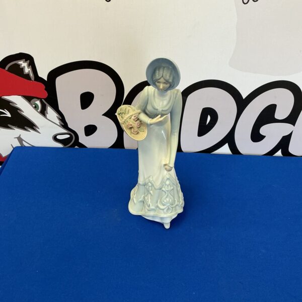 Vintage Spanish porcelain lady figurine, detailed and collectible.