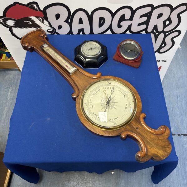 Lot of three vintage barometers on a blue surface.