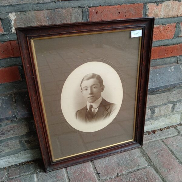 Antique portrait print of a young gentleman in a dark frame.