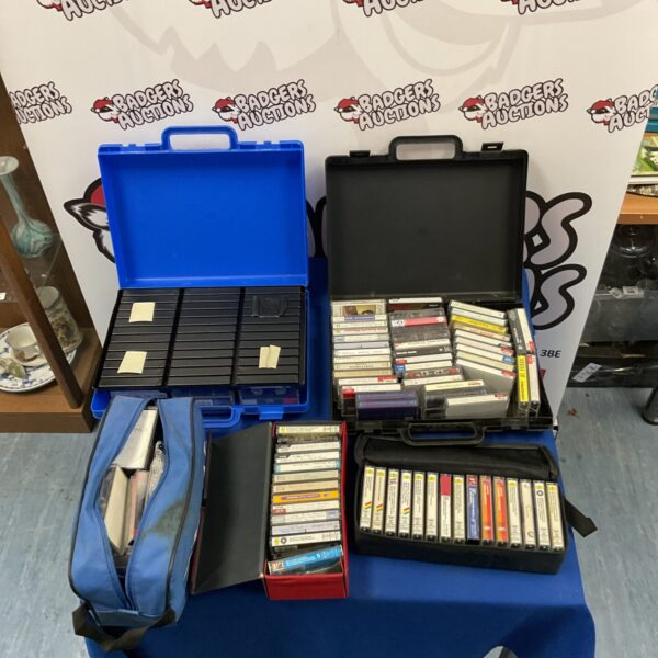 Blue carrying case filled with a large lot of vintage cassette tapes.