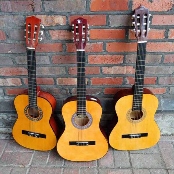Lot of three children's acoustic guitars for beginners.