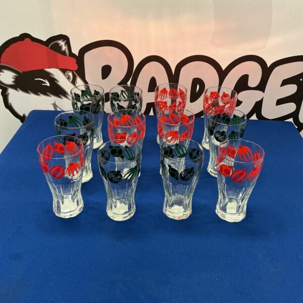 Vintage Coca Cola tumblers set displayed on a blue background.