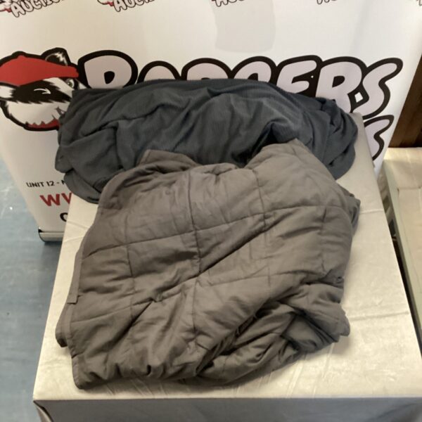 Grey weighted blanket with textured surface, ideal for comfort.