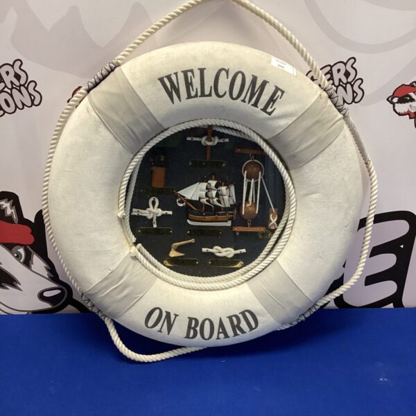 Vintage life ring diorama with sailing ship scene.