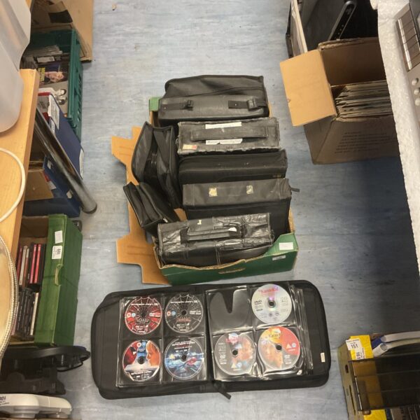 Stacked DVD cases filled with a large movie collection.