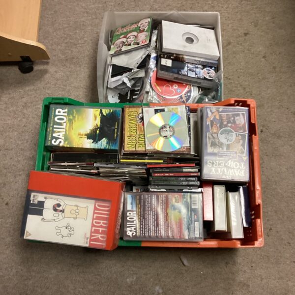 Mixed lot of DVDs and CDs for entertainment and collecting.