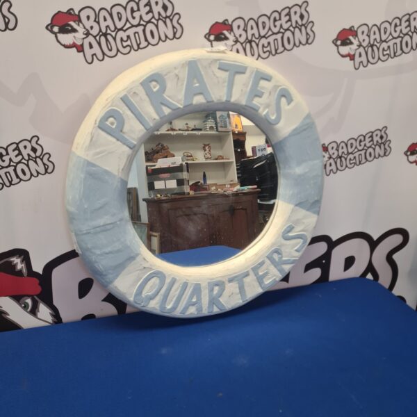 Detailed pirate ship hanging mirror for nautical decor.