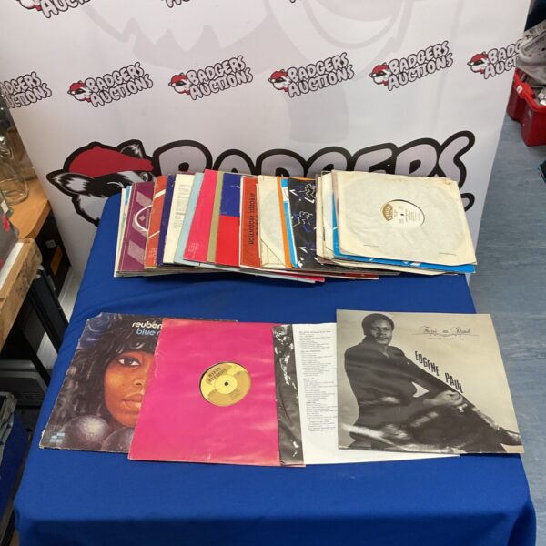 Collection of vintage reggae vinyl LP records on a table.