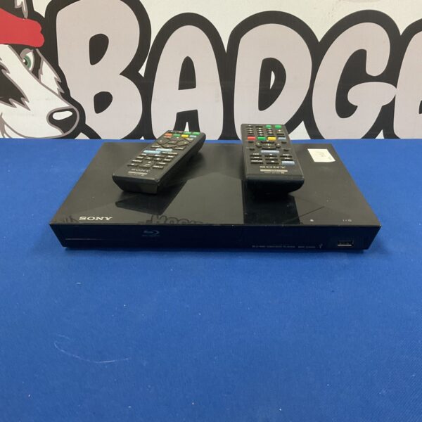 Black Sony BDP-S1200 Blu-Ray player with remote control.