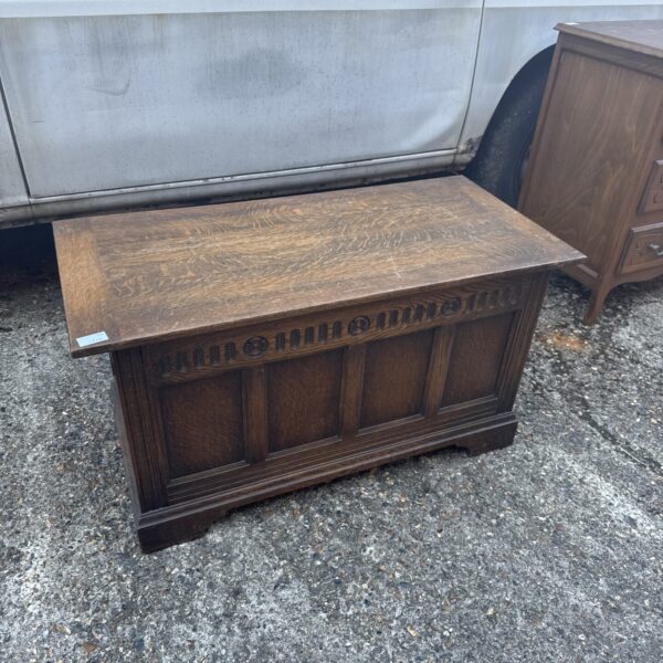 Front view of a vintage oak chest by Hunters of Derby.