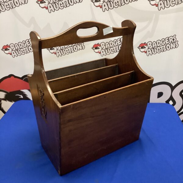 Vintage wooden magazine rack for storing reading materials.