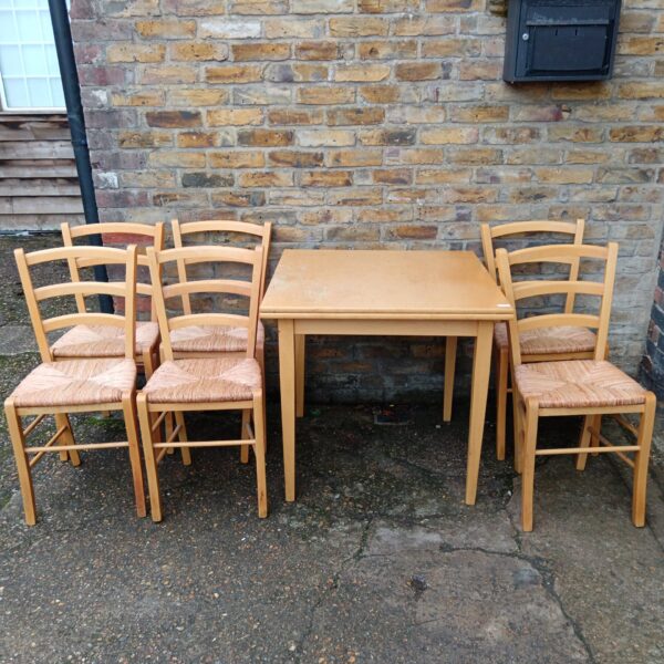 Vintage extending dining table with six bull rush chairs.