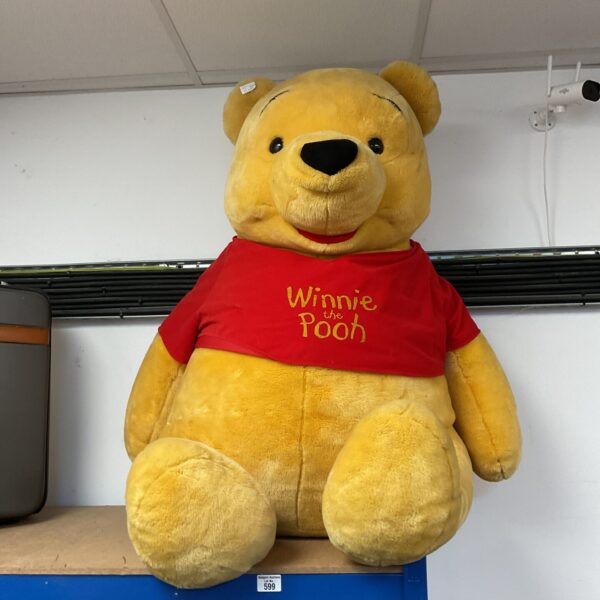 Large yellow Winnie the Pooh teddy bear, soft plush toy.
