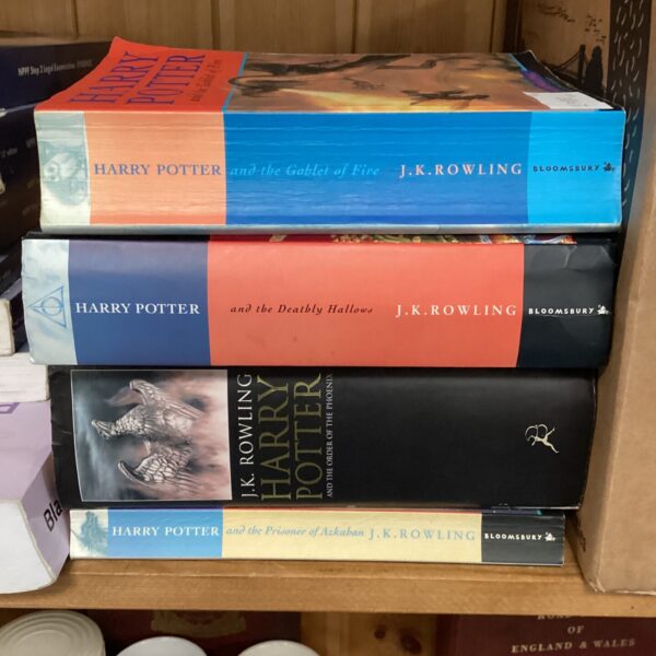 Colourful collection of Harry Potter first edition books by J.K. Rowling.