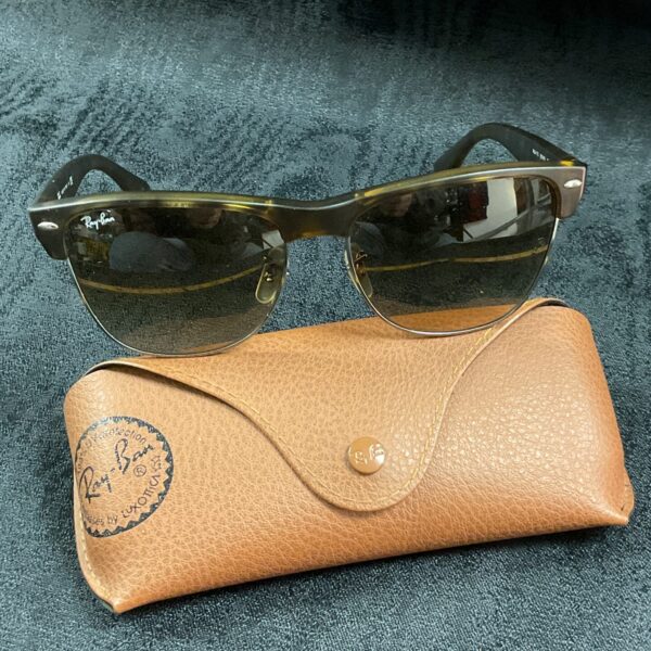 Vintage Ray Ban Wayfarer sunglasses with tortoise shell frame and case.