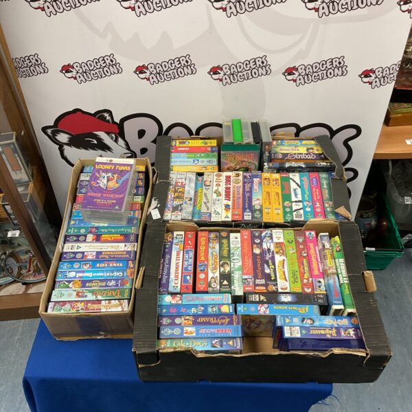 Vintage VHS tape lot in three boxes, retro movie collection.