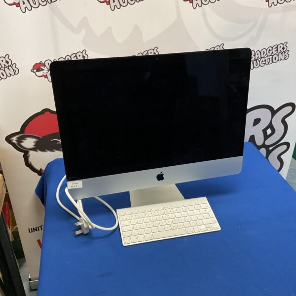Apple iMac A1418 all-in-one desktop computer with wireless keyboard.