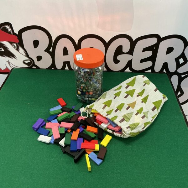 Colourful wooden building blocks and marbles in a tub.