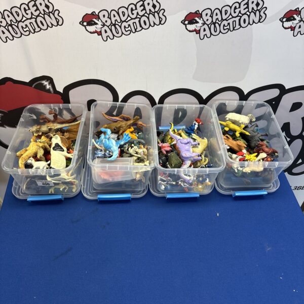 Four boxes of plastic farm animals and toy figures.