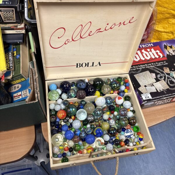Vintage marbles collection in a wooden box.
