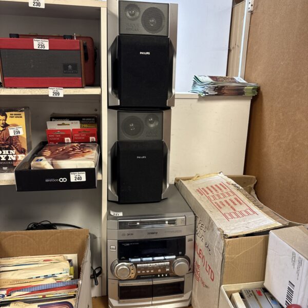 Vintage Phillips CD player and bass speakers for audio enthusiasts.