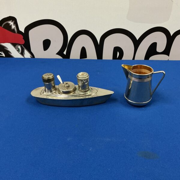 Vintage silverplate cruet set in ship design for condiments.