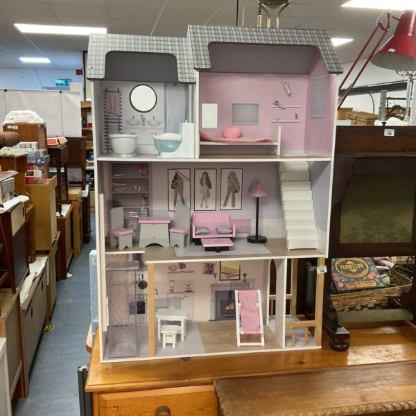 Vintage Sindy dolls house with colourful rooms and furniture.