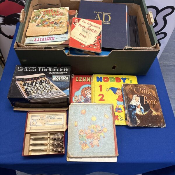 Vintage toy and book lot featuring an electronic chess set and children’s books.