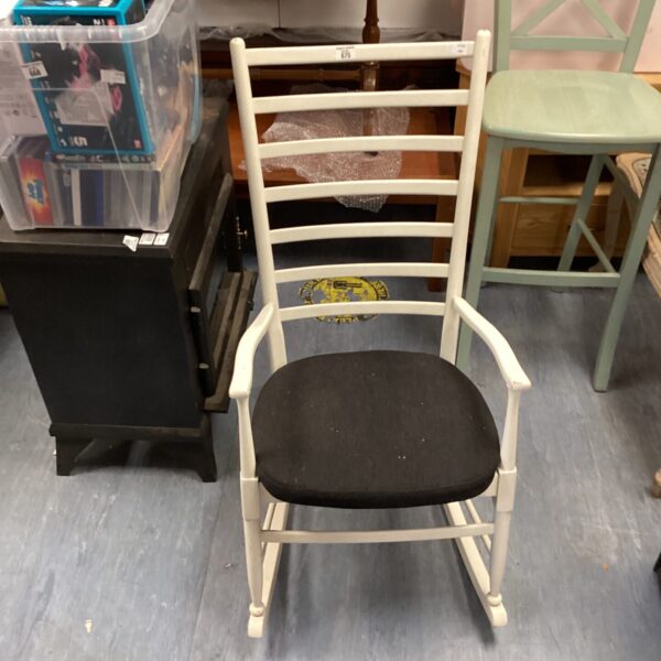 White painted wooden rocking chair with black seat.