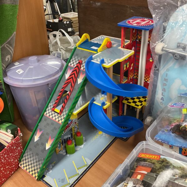 Colourful wooden garage playset with lift and car wash.